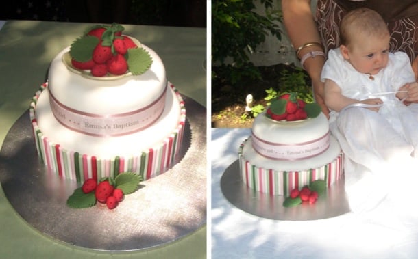 White royal icing cake with red, pink and green batons and loads of luscious strawberries