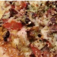 Home made wood fired pizza seasoned with italian spaghetti herbs