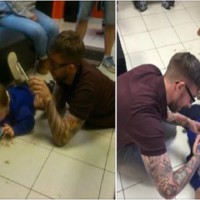 British barber wins internet for laying on the floor with autistic boy