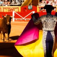 Shocking image of a bull fighter with his baby daughter in the ring