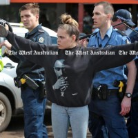 BRAVE young girl protects police during riots