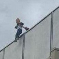 BABY dangled over balcony during party