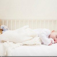 What should I do if my baby rolls over in her sleep?