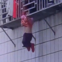 Toddler left dangling from a fourth-story window after falling