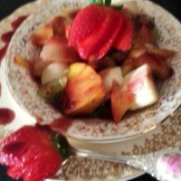 Fresh fruit salad with berry coulis