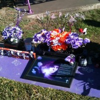 Mum warned to tone down her daughter's purple gravesite