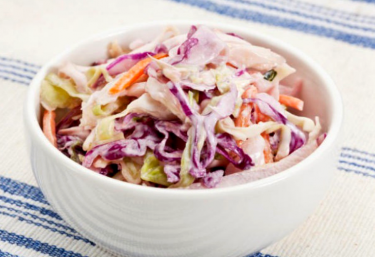 White bowl filled with Mayo Free Creamy Coleslaw made with red and white cabbage as well as shredded carrot