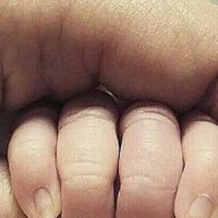 The photo of a tiny newborn hand people are calling 'creepy and not safe'
