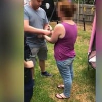 Woman caught 'trying to kidnap a young child' who was playing in his yard