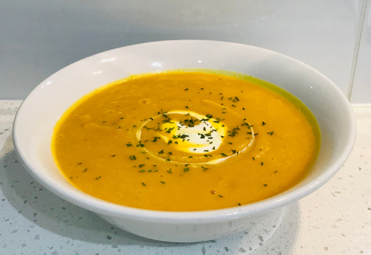 hot pumpkin soup, creamy, sprinkled with herbs