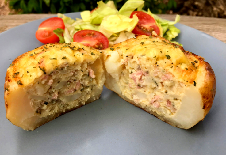 A quiche stuffed baked potato with salad