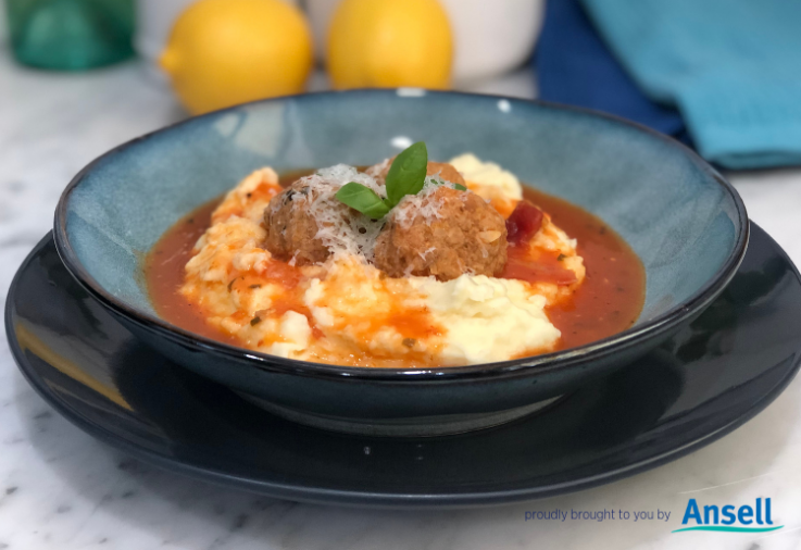 Blue bowl with mashed potatoes and meatballs with rich tomato sauce