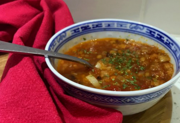 Small blue and white asian style bowl filled with delciious tomato and lentil soup