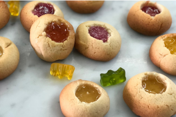 Small round biscuits with a well in the centre filled with melted gummy bears