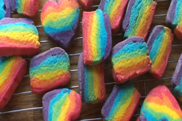 Rainbow coloured biscuits arranged on a wire baking cooling rack - How to make Rainbow Biscuits