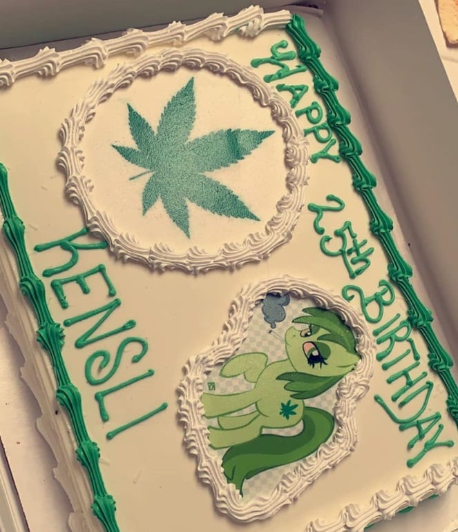 A close up shot of a rectangular birthday cake decorated with a huge icing marijuana leaf and stoned green My Little Pony.