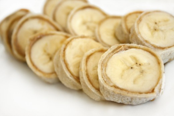 Banana Sushi made with a fresh wrap, spread with a little peanut butter and a whole banana inside. Roll up and then slice through to resemble sushi slices