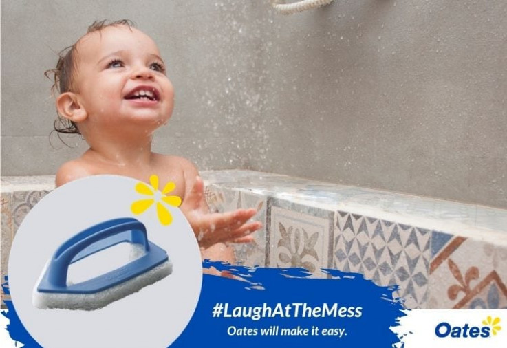 child in shower with Oates Light Duty Corner Scrub Brush in foreground