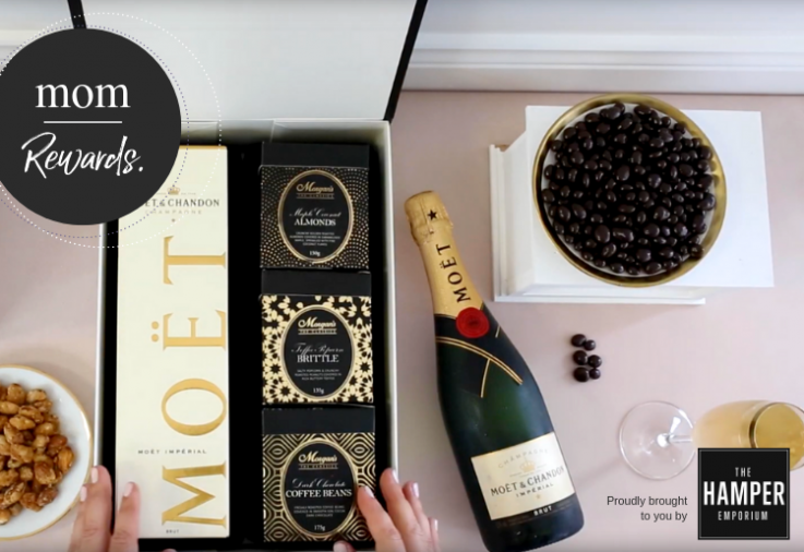 Content of a hamper showing a bottle of moet champagne with chocolates