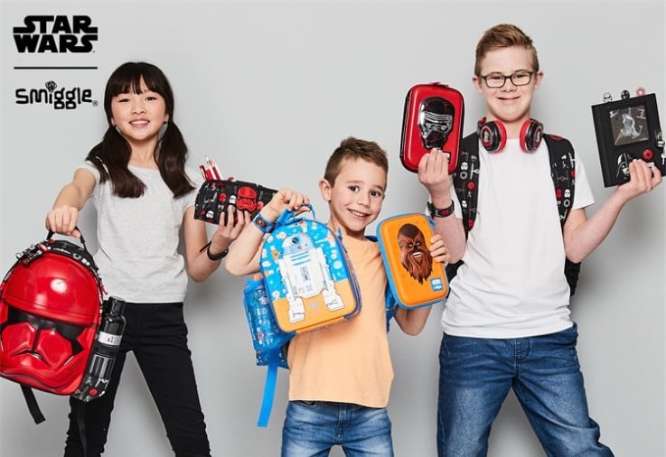 A group of children holding Smiggle products