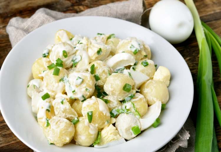 potato salad made with baby potatoes spring onions boiled eggs and a creamy dressing