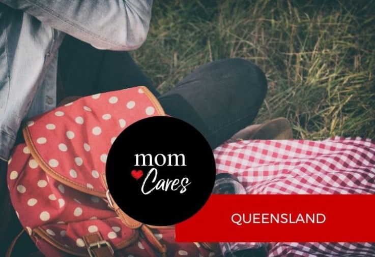 backpack and picnic blanket on grass in queensland