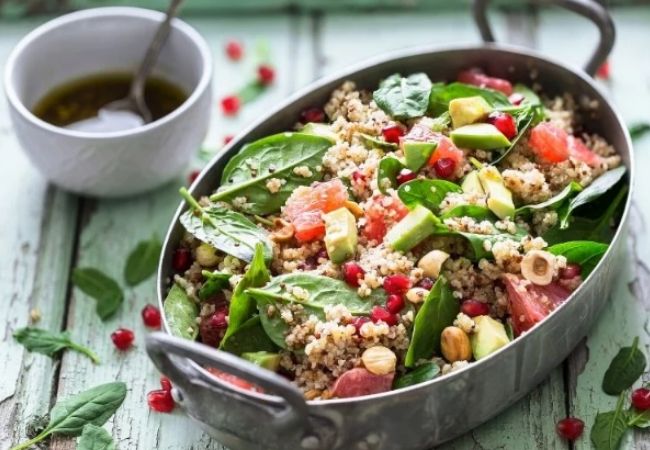 Salad Recipes_quiona salad with plenty of fresh green leaves and pomegranate arils served in a tin oval salad plate