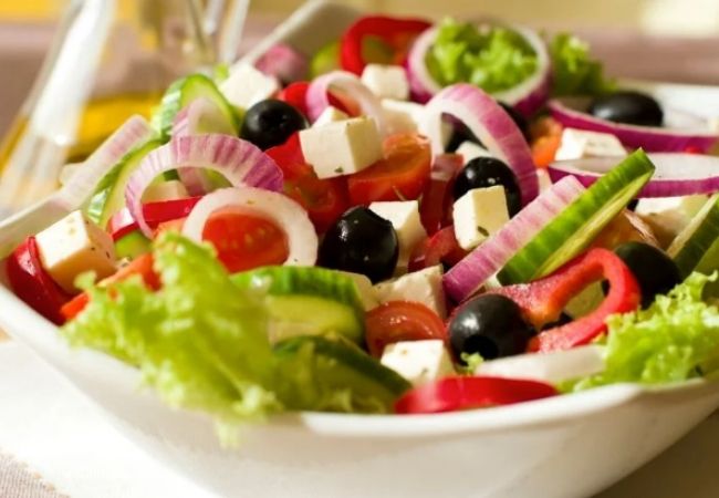 Salad Recipes_greek salad made with lettuce, cucumber, onion, black olives, fetta cheese, capsicum and a light olive oil and lemon dressing