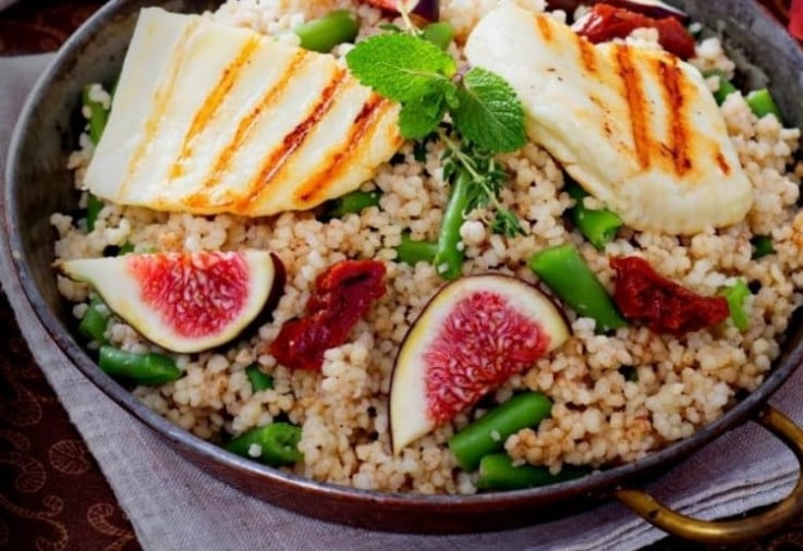 Halloumi, Couscous and Fig Salad served on a large platter set on a linen napkin