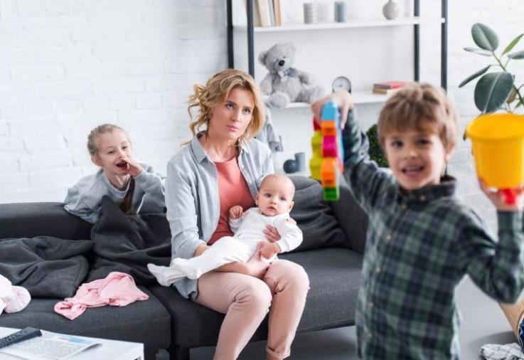 respect Tired mother on couch with kids being cheeky