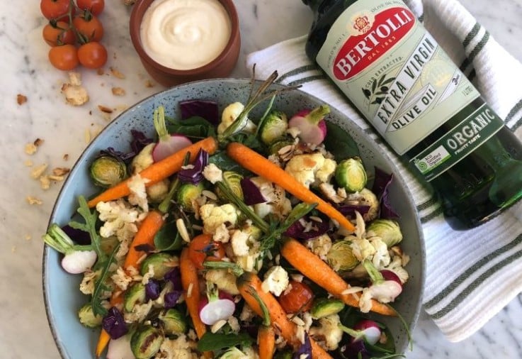 Roast Vegetable Salad with Garlic Aioli served in green salad bowl with bottle of Bertolli Organic Extra Virgin Olive Oil