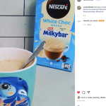 little girl in kitchen with NESCAFÉ Café Creations White Choc Mocha Inspired by Milkybar in mug with box