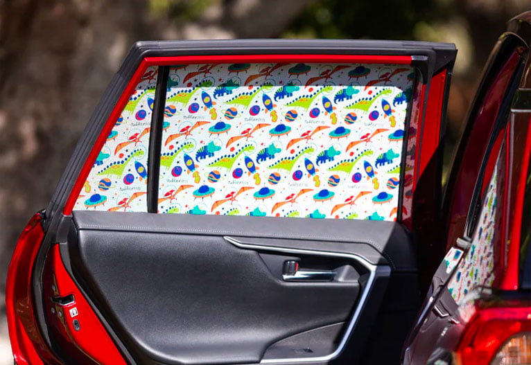 Toddler Tints baby car window shade on a red car. 