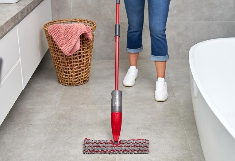 woman mopping tiles with the Vileda ProMist Max Flip Spray Mop Scrub Refill