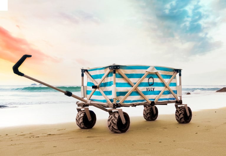 Vuly beach cart on a beach at dusk.