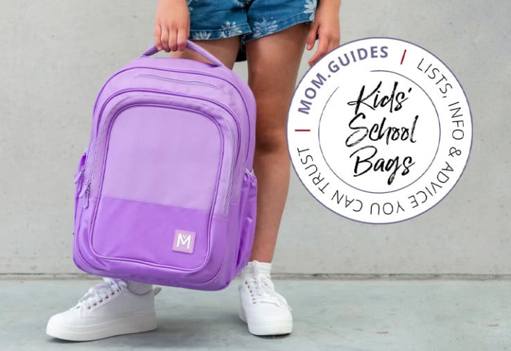 Child holding a Montii Co kids' purple school backpack.