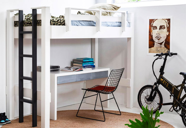 White loft bed with black ladder in a teenager's bedroom.