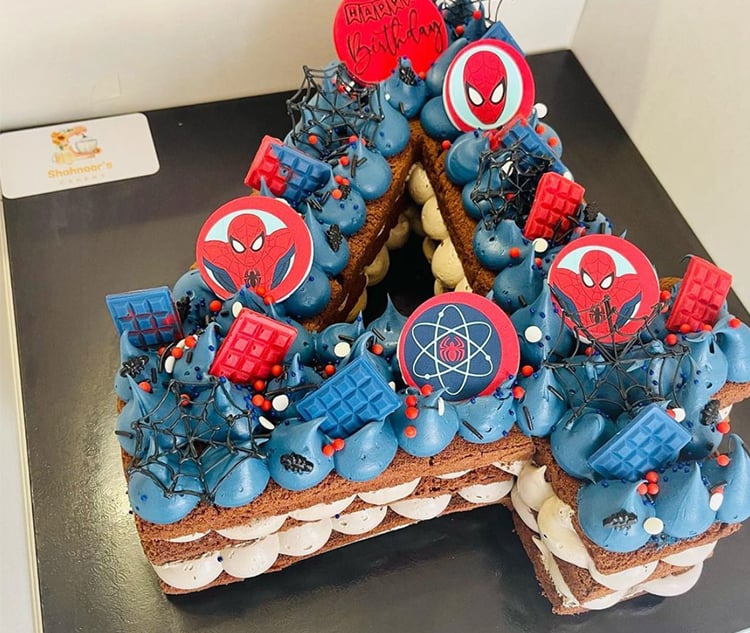 Layered superhero cake in the shape of a number 4.