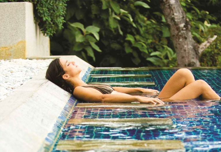 Woman soaks in the shallows of a magnesium pool.