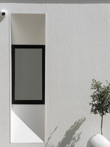 White external wall of a modern house with a black window.