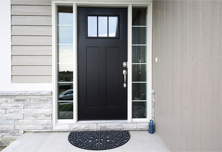 Entrance of a house with a black door.