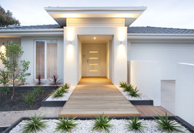 Front of a modern house with a white front door.