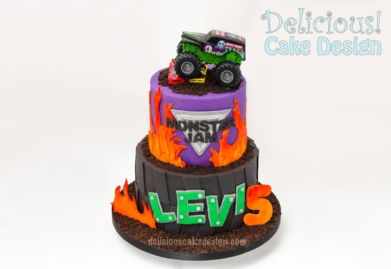 Two-tiered novelty birthday cake with a monster jam truck on top.