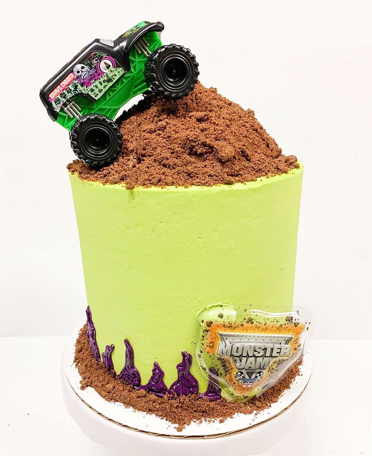 Tall birthday cake with truck on top by Heather Madison.