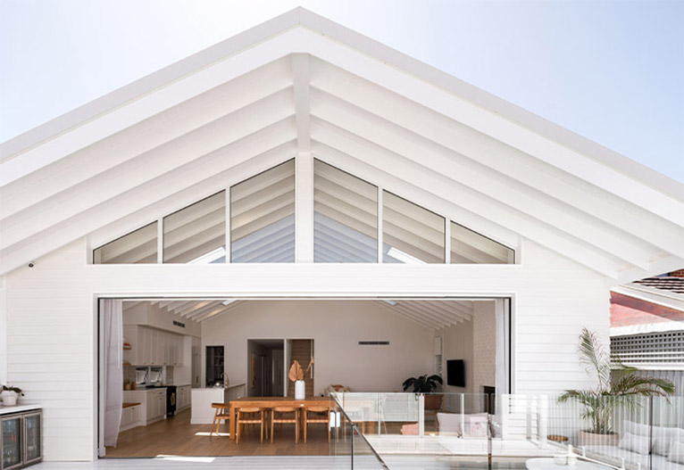 Back view of a modern white beach house finished in Linea Weatherboard by James Hardie.
