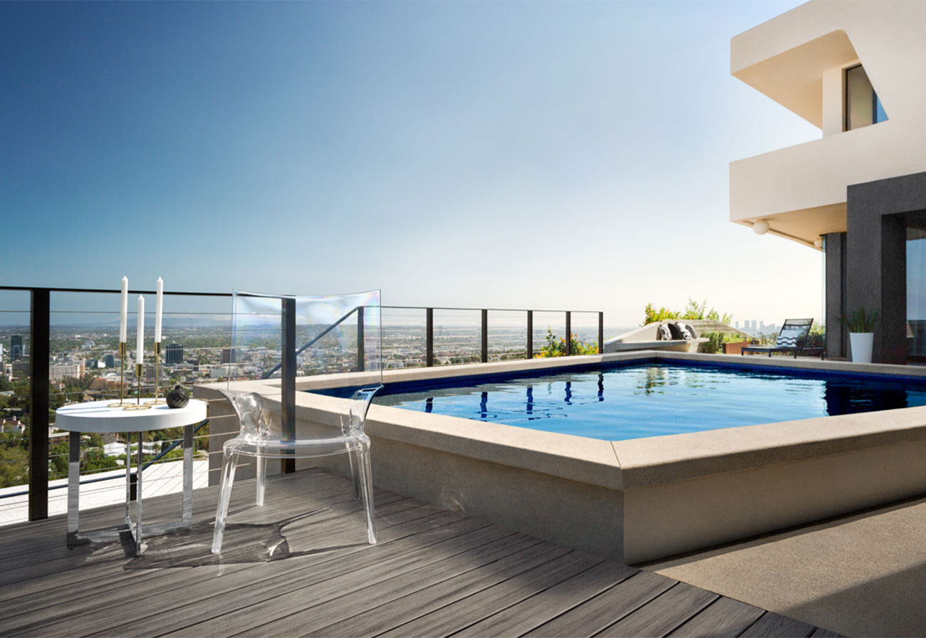 Rooftop pool and deck of an apartment building with view of the city.