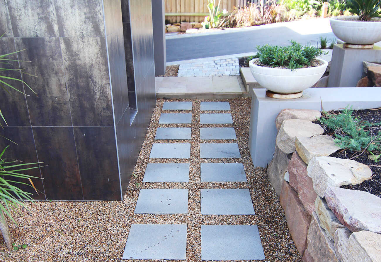 Pavers arranged in a stepping stone pattern at a modern house.