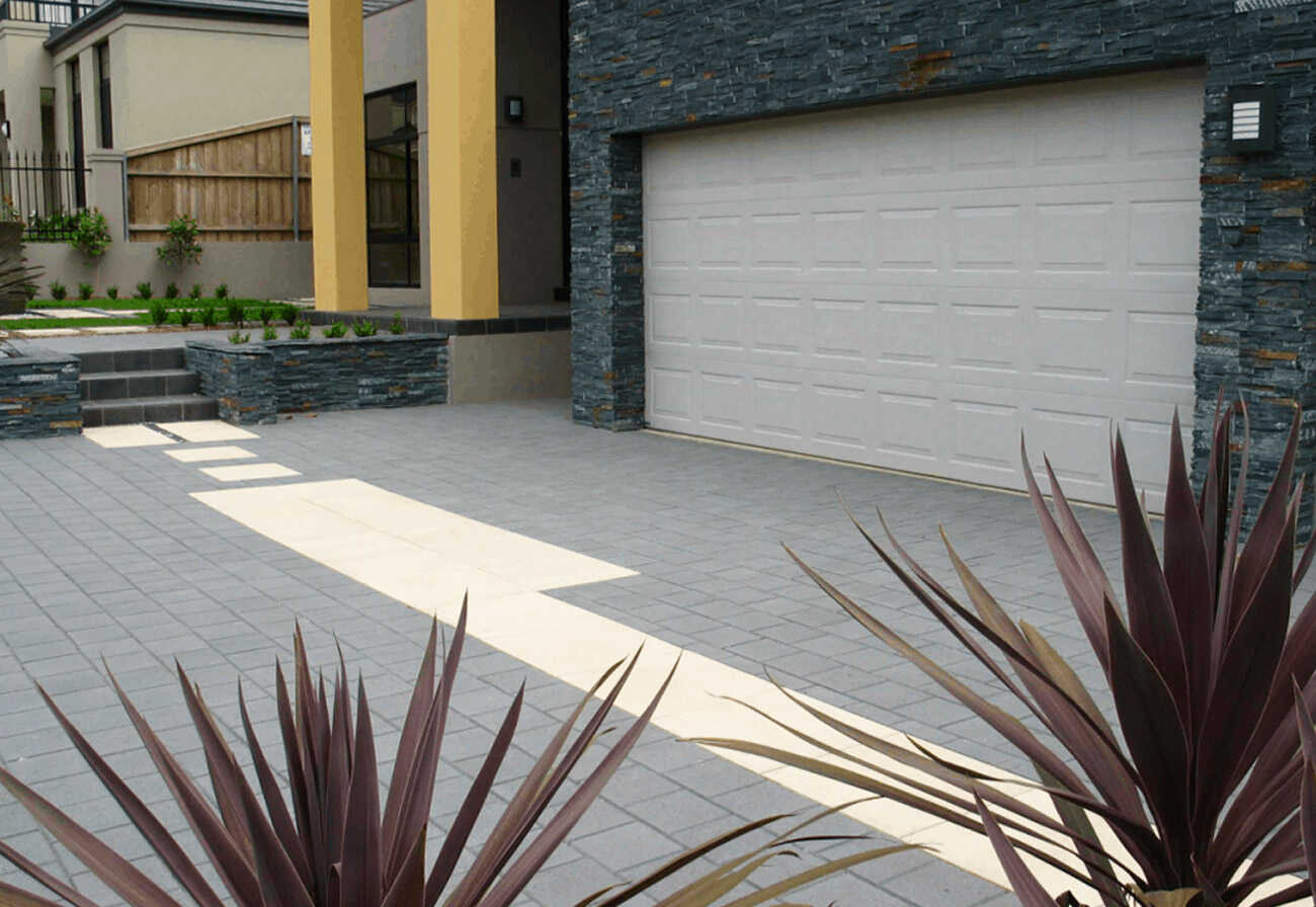 Beige concrete pavers used for the surface of a double driveway.