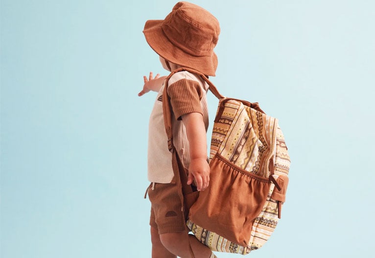 Child wearing a hat and a Banabae backpack.