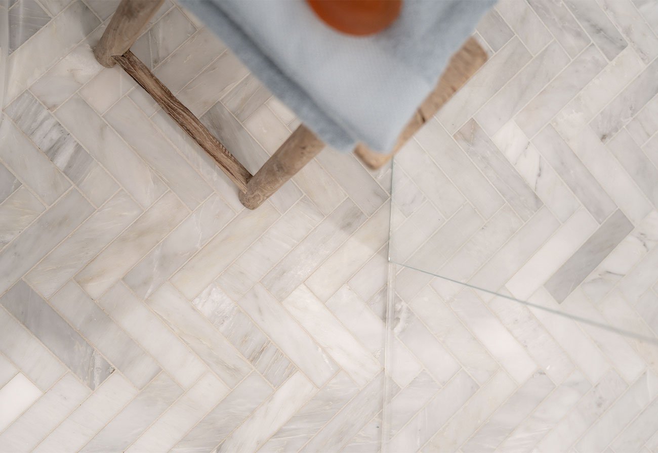 The Calacutta Herringbone Mosaic tiles come in sheets for fast installation!